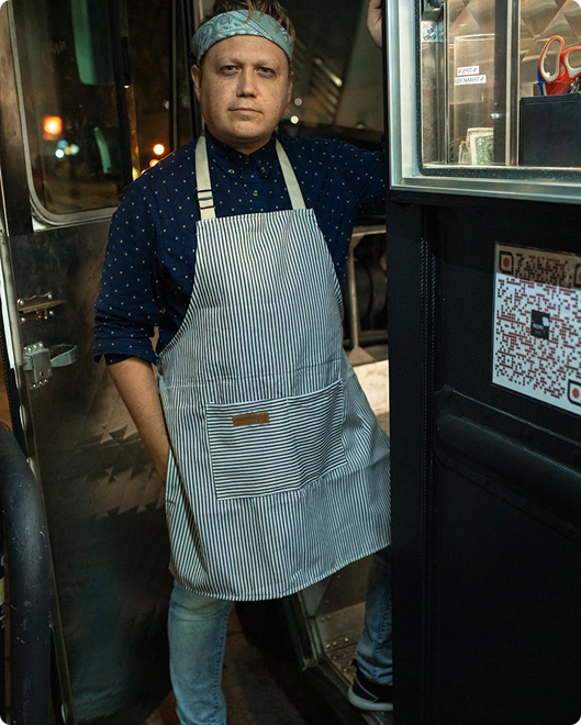 Chef standing confidently in front of a food truck